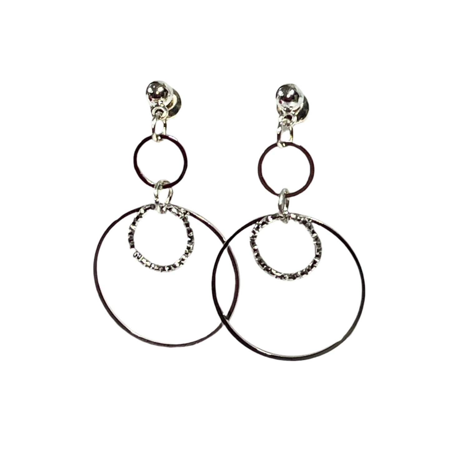 Pair of hoop earrings with smaller circular charms on a white background