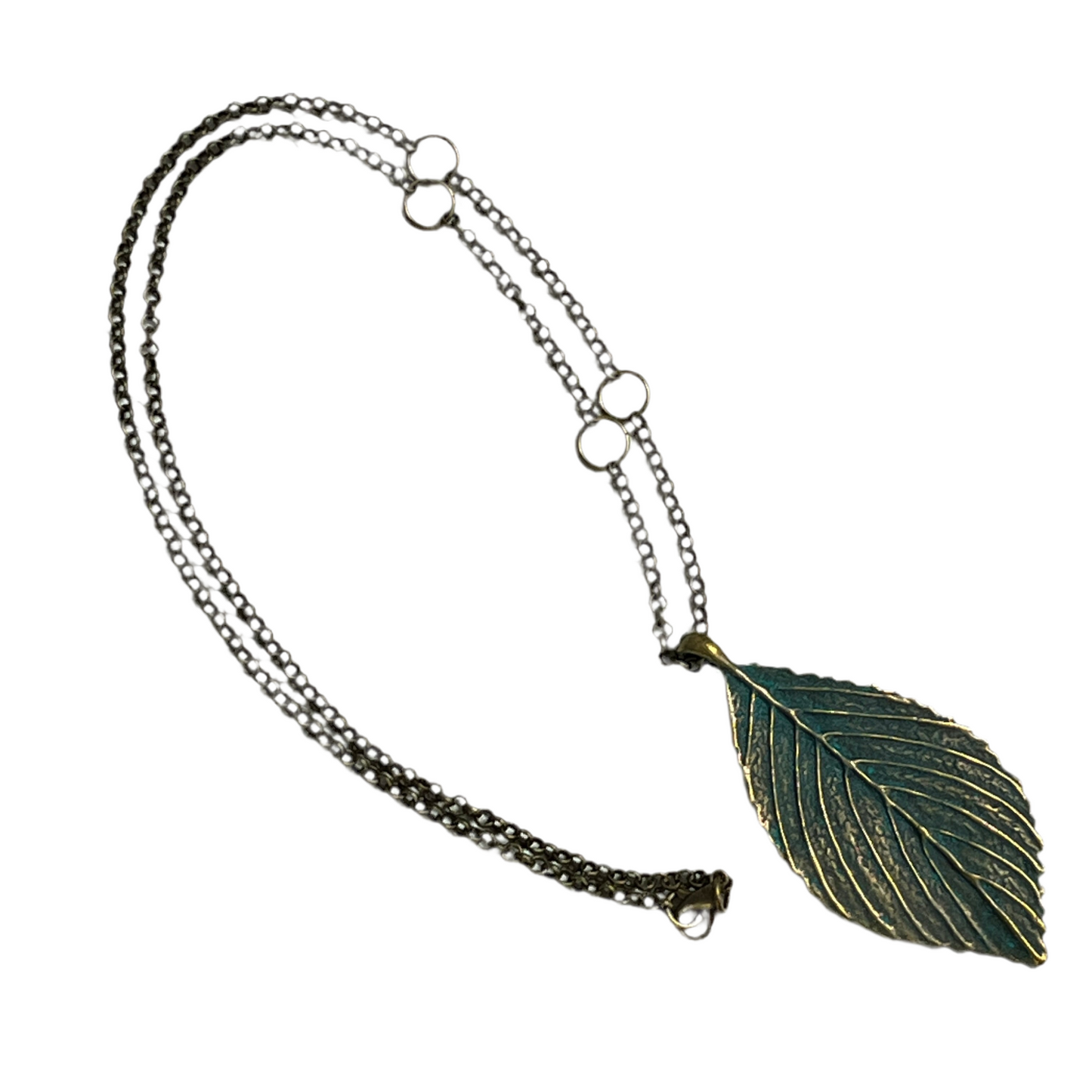 Necklace with a leaf-shaped pendant on a white background