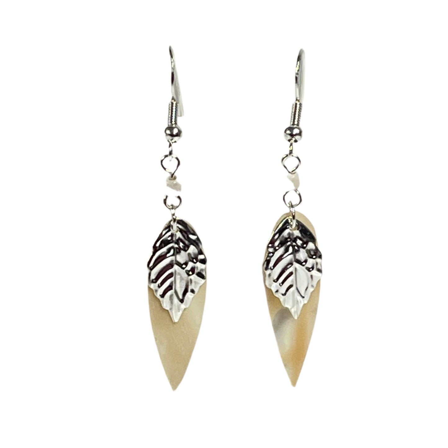 Pair of earrings with shell leaf-like designs on a white background