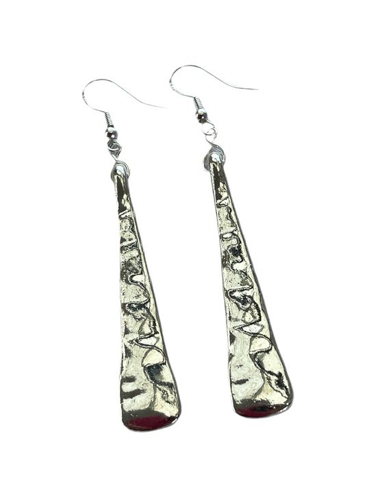 Pair of long silver teardrop earrings on a white background
