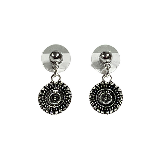 Pair of silver earrings with circular designs on a white background