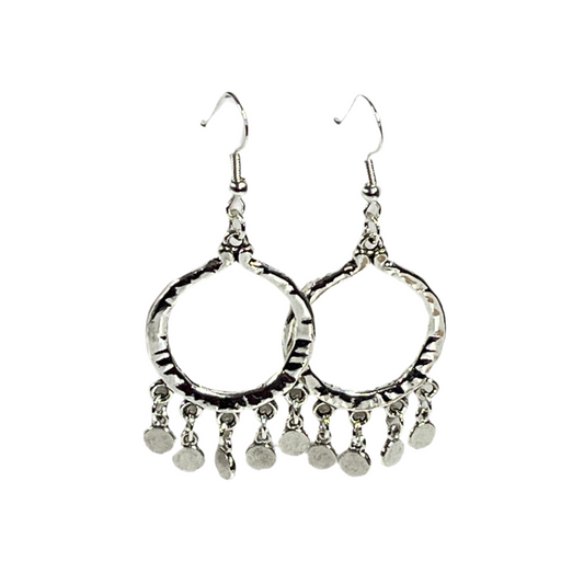 Pair of silver hoop earrings with dangling silver coins on a white background
