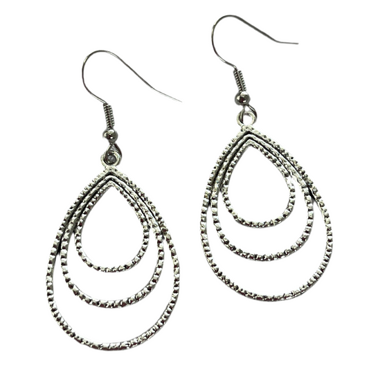 Pair of silver triple wire teardrop earrings on a white background