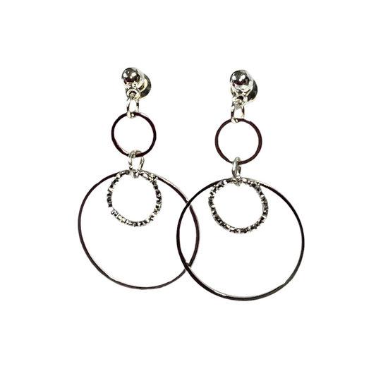 Pair of hoop earrings with smaller circular charms on a white background
