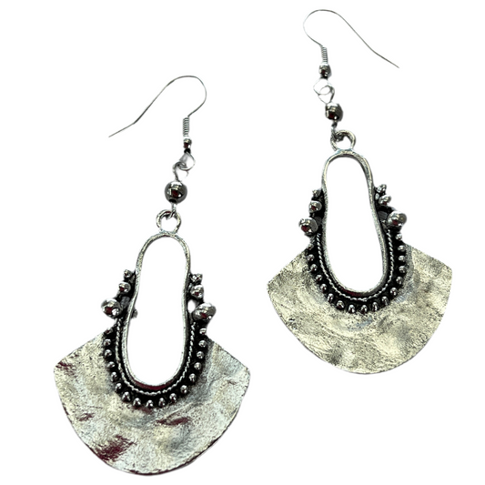 Pair of silver antique look earrings on a white background
