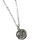 Silver koru spiral pendant necklace on a white background