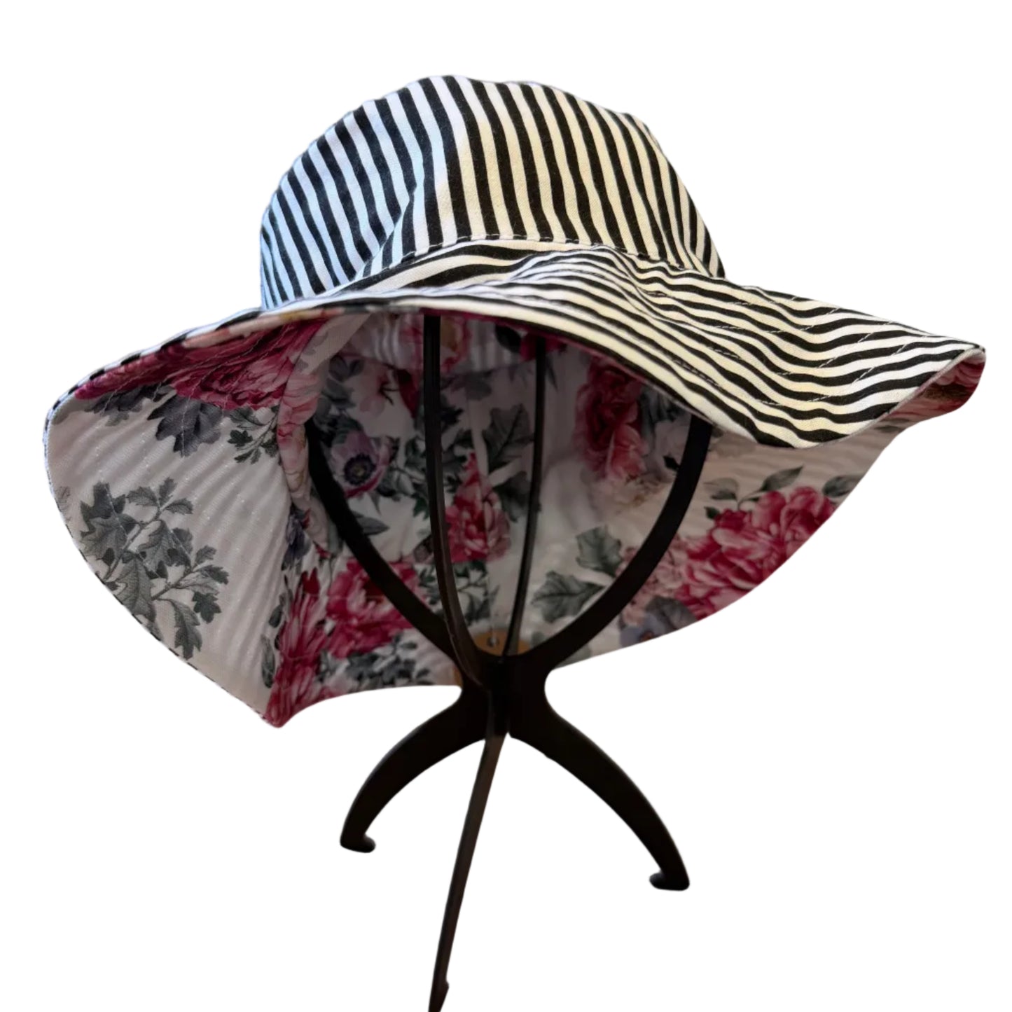 Striped sun hat with floral lining on a stand in a home setting