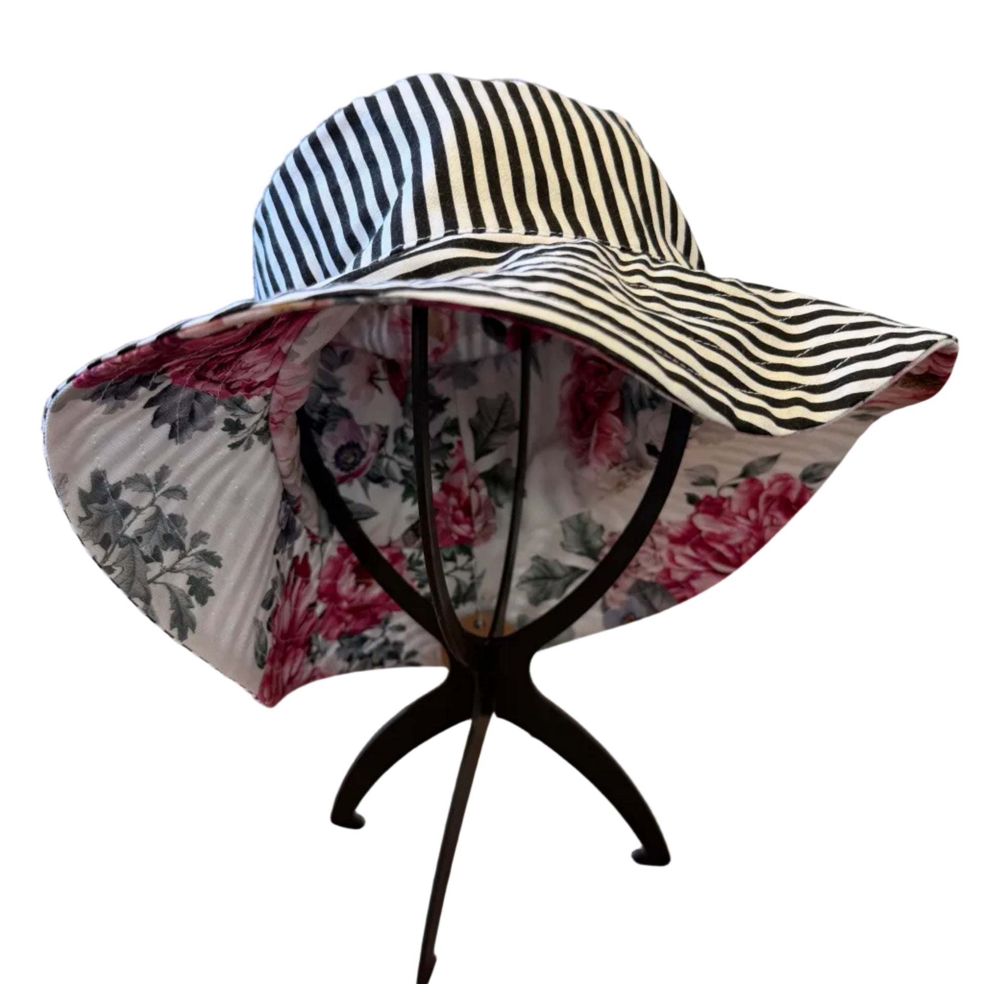 Striped sun hat with floral lining on a stand in a home setting