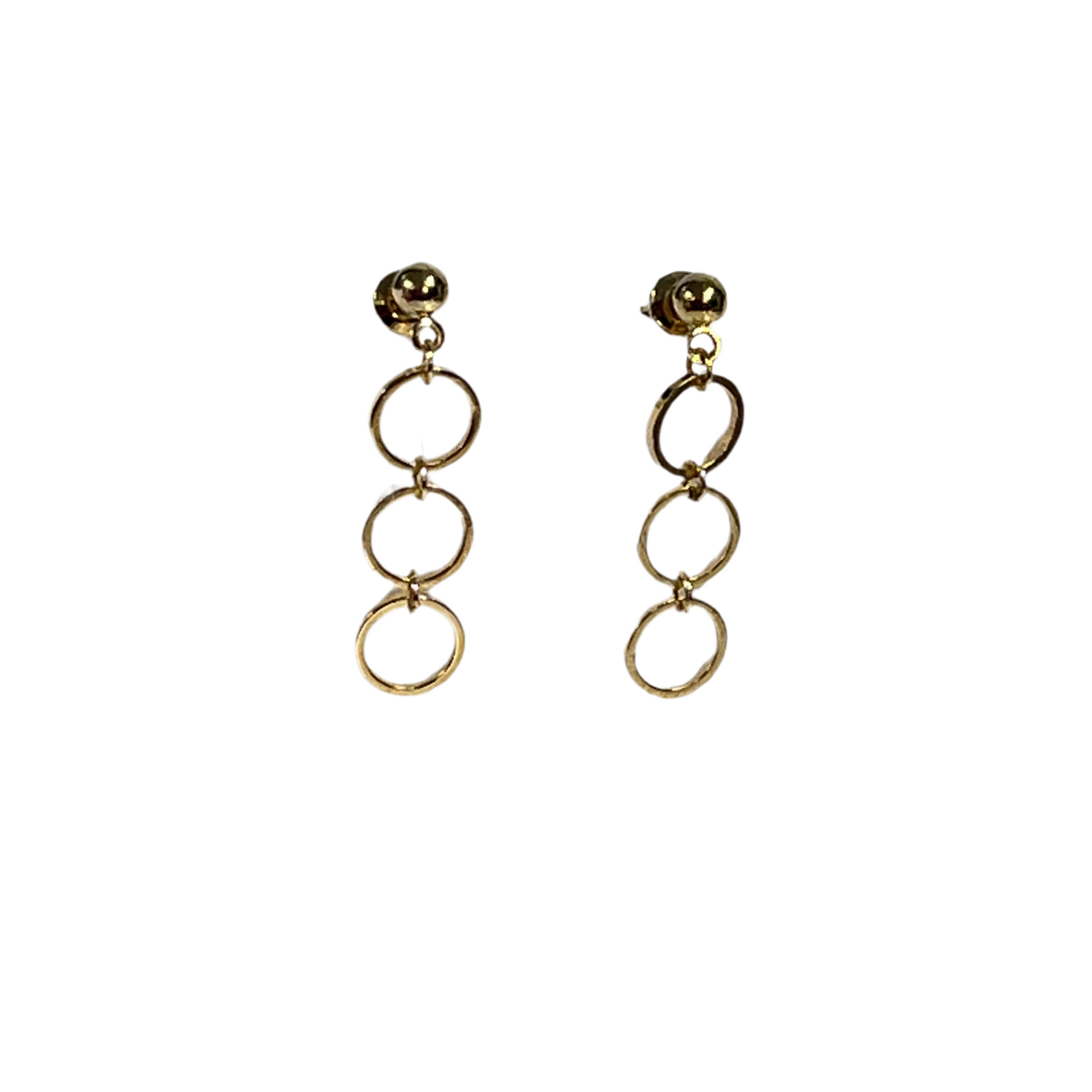 Gold circular earrings on a white background