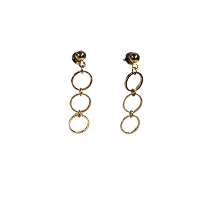 Gold circular earrings on a white background