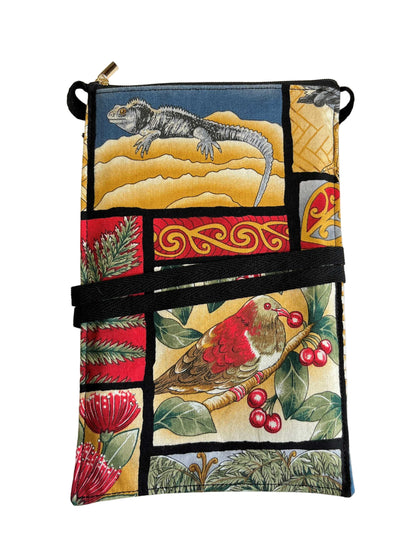 Handmade mobile phone bag with Kiwiana patchwork print featuring iguana, wood pigeon, and native flora.