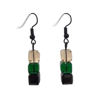 Pair of earrings with green, black, and champagne square beads on a white background