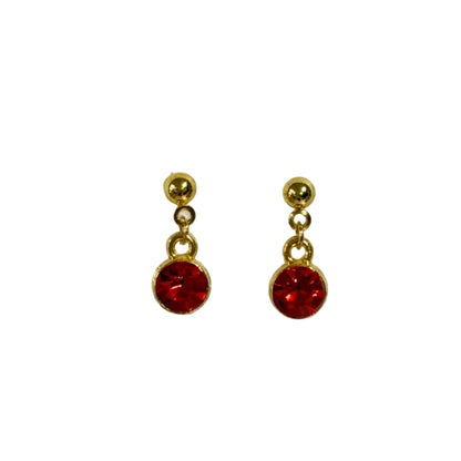 Gold earrings with red gemstones on a white background