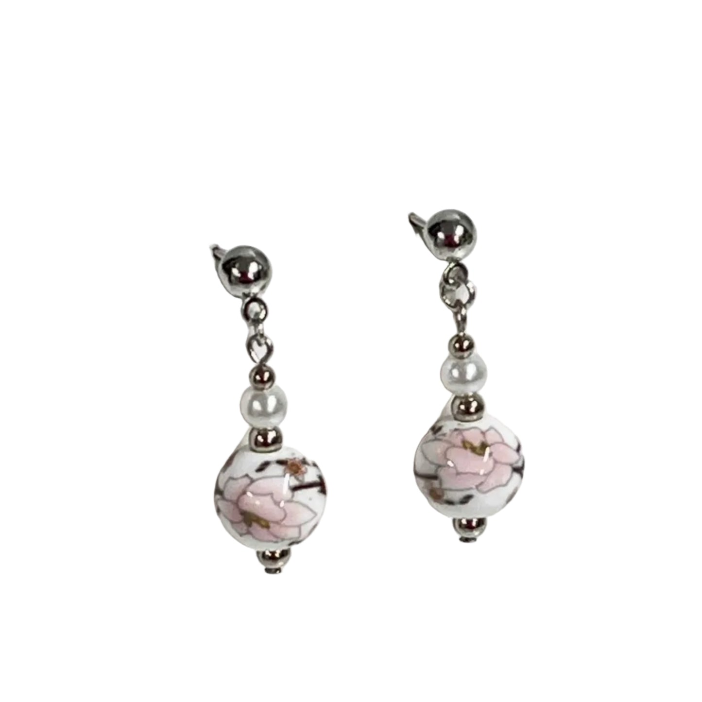Pair of earrings with floral design on a white ceramic beads