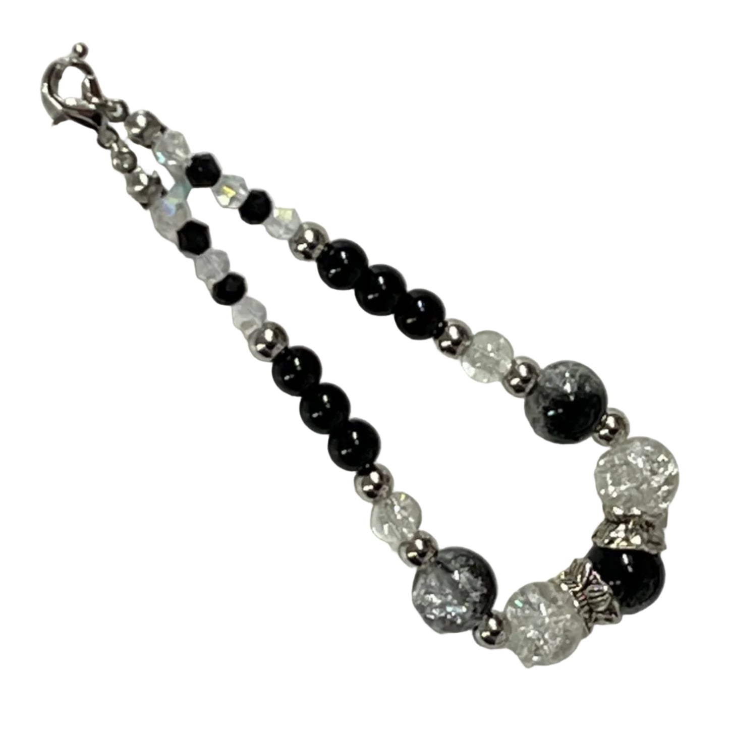 Beaded bracelet with black, white, and silver beads on a light gray background