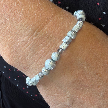 Silver beaded bracelet on a wrist