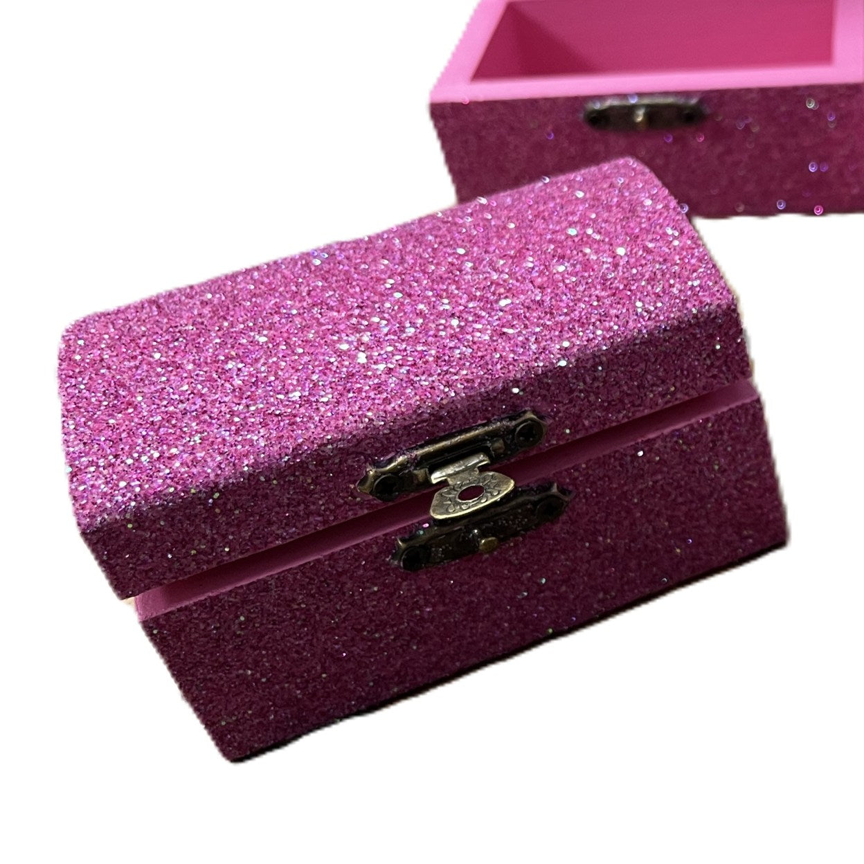 Pink glittery jewelry box with a gold clasp.