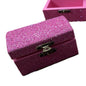 Pink glittery jewelry box with a gold clasp.