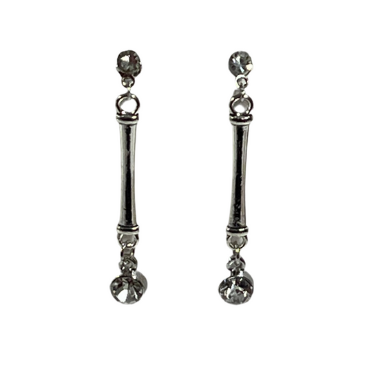Pair of silver earrings with dangling rhinestones on a white background