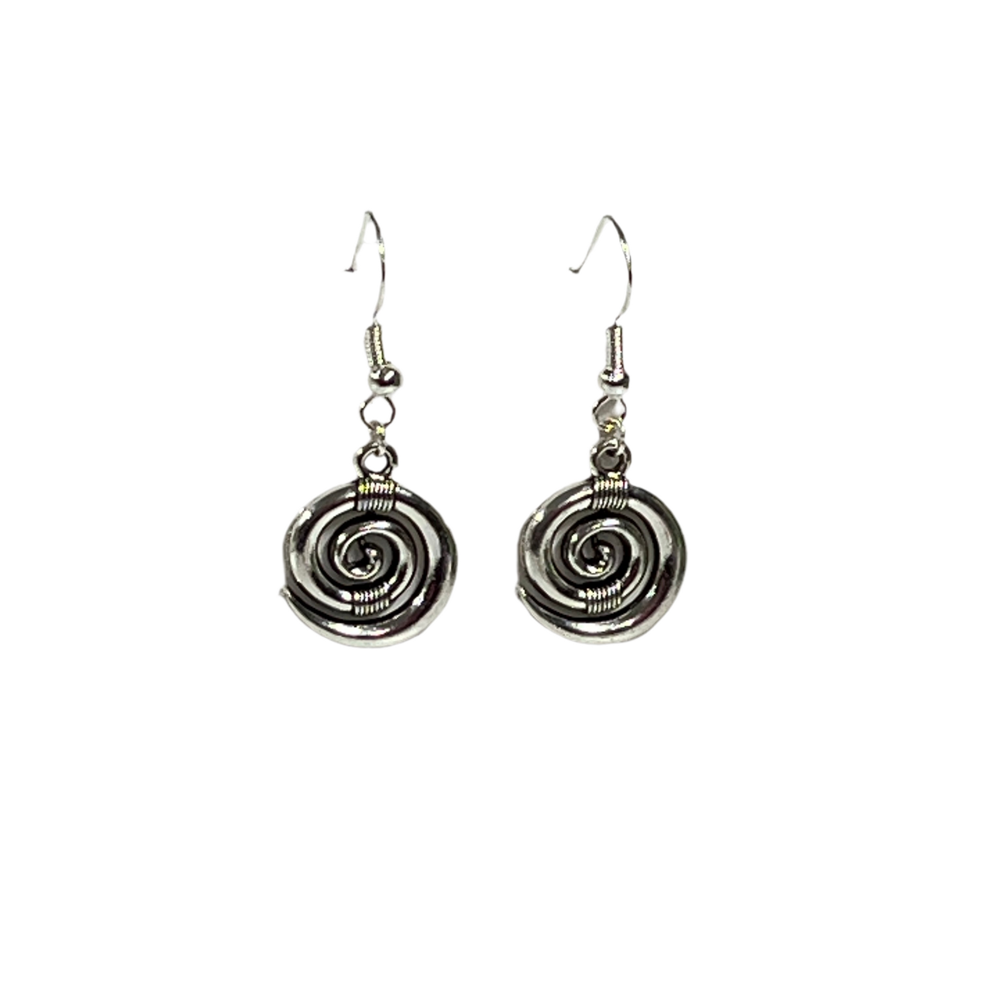 Pair of silver koru spiral earrings on a white background