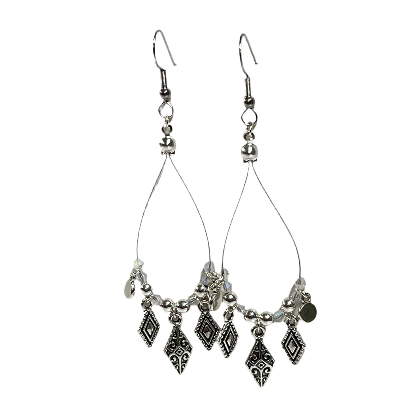 Silver teardrop earrings with dangling charms on a white background