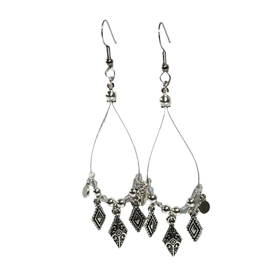 Silver teardrop earrings with dangling charms on a white background